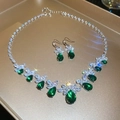 Silver jewelry set with emerald teardrop gems and marquise stones on a gold tray - 102# Necklace-Green