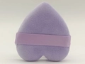 Detail of light purple heart-shaped powder puff with satin ribbon handle on white background - Purple