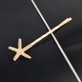 Detailed view of a golden starfish hair clip with realistic textures on a black background - Single Small Starfish Bobby Pin / Gold