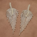 Detail von eleganten Blatt-Ohrringen in Gold mit funkelnden Strasssteinen und Quasten - Gold