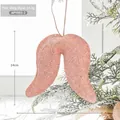 Pink glittery Christmas wing ornament hanging on a frosty tree, 16cm festive decoration - Pink Wings