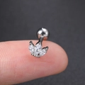 Macro shot of silver zircon crown cartilage stud earring held on fingertip for size - Style CC003-14 / Lotus Design Stud / White Gold