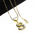 Detailed macro view of gold-plated letter S pendant with colorful cubic zirconia stones - Pendant with Necklace / S