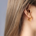 Elegant gold hollow star earrings for women shown worn on a model in a minimalist style - Gold