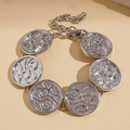 Detailed view of silver metal bracelet featuring textured circular disks and chain - Silver