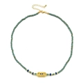 Detail van de turquoise kralenketting met gouden Evil Eye reliëf hanger en kreeftsluiting - Turkoois Kralen - Vierkante Blauwe Hanger