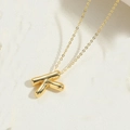 14K gold plated initial K pendant necklace with mirror finish on a stone background - Letter K