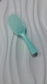 Light blue macaron-colored anti-static massage hairbrush with white bristles on wave texture - Green