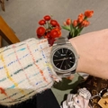 Close-up of a silver Dimini watch with a black square dial on a woman's wrist - Silver Case Black Dial