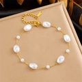 Elegant gold chain bracelet with irregular white pearls on a beige display stand - Gold Chain Irregular White Pearl (B1348)