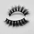 Close-up of thick curly black false eyelashes with clear roots on a white background - D802