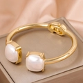Elegant gold-tone hinged cuff bracelet featuring dual large square white faux pearls - Gold Square Pearl
