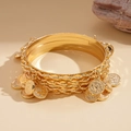 Macro detail of multi-layer gold bangle set with vintage coin charms and bohemian design - Gold (5-Piece Set)