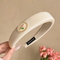 Elegant cream padded headband with pearl tulip emblem and handmade label detail - Tulip White Headband