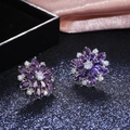Detailed view of luxury sunflower stud earrings with purple and white zircon in silver - Silver + Purple