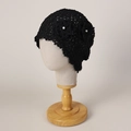 Detail of hand-crocheted black cloche hat featuring intricate hollow patterns and pearl flower - M (56-58cm) / Black
