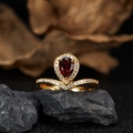 Macro shot of a V-shaped S925 silver ring with 18K gold and a pear-cut red garnet stone - Natural Garnet V-Shape Ring LR377