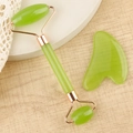 Macro detail of resin jade roller and heart gua sha set on wooden spa background - Resin Roller Transparent Green