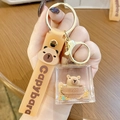 Capybara keychain with liquid sand charm and brown silicone wrist strap held by hand - Square Capybara - Bathing