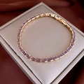 Detailed macro view of gradient purple marquise-cut zircon stones on a rose gold bracelet - Rose Gold Plated Purple Marquise Style
