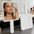 White handheld square vanity mirror for makeup on a grey countertop in a bright bathroom - 7.5*13.5cm Square Mirror / White
