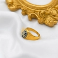 Close-up of golden ring with oval Dalmatian Jasper stone on elegant white silk fabric - Dalmatian Jasper