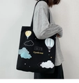 Detail of a large black canvas tote bag featuring colorful hot air balloon print and long straps - Hot Air Balloon Black