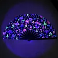 Detail of UV reactive folding fan with neon mushroom patterns glowing under purple light - Starry Mushroom Fluorescent Style (A56-UV)
