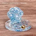 Cat paw resin ornament with aquamarine crystals and blue glitter on a clear base - Aquamarine with Sequins