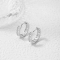 Detailed view of silver hoop earrings featuring square-cut sparkling zirconia on white stone - Silver Clear Zirconia