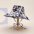 Double-sided sun hat with dark blue floral print and chin strap on a wooden stand - Flower Style / Navy Blue