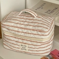 Detail of striped quilted makeup bag with soft texture and sturdy top handle - Makeup Bag / Pink