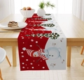 Detail of linen Christmas table runner featuring snowman and tree patterns on wood table - Snowman/Christmas Tree/Snowflake/Red White / 33*183cm