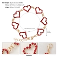 Detailed view of gold plated heart bracelet with red rhinestones and lobster clasp - Gold (Heart Chain)