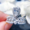 Macro shot of a pear-cut cubic zirconia ring with an intricate V-shaped hollow silver band - Ur0676