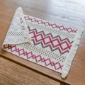Bohemian woven placemat with red and coffee geometric patterns and fringed edges - Red Brown Wave Grid
