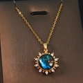 Macro view of golden planet pendant with blue nebula center and sparkling rhinestones - Gold - Starry Sky Round