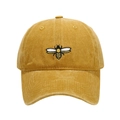 Close-up of high-quality bee embroidery on a vintage yellow washed cotton baseball cap - Adjustable / Yellow