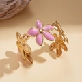 Detail of gold floral open bangle with pink enamel flowers on warm marble surface - Bracelet - Pink - Small Flower