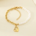 Detail of heart pendant with family engraving and pearls on a gold chain bracelet - Heart Family Image (KB203699-Z)