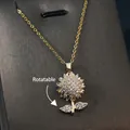 Golden rotatable sunflower pendant necklace with zircon insets on a grey textured background - Gold - Rotating Sunflower Gold Leaf