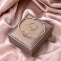 Detailed view of gold hollow heart bracelet and matching ring set on silk background - Heart Bangle and Ring Set (S284-2)