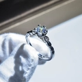 Close-up of a brilliant-cut gemstone ring held by a gloved hand with bokeh background - Adjustable Open / Large Brilliant Cut Style (11)