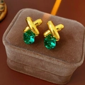 Macro shot of vintage cross earrings with green cube pendants on brown velvet box - Silver Earring Post - Gold - Green
