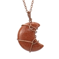 Detail view of handmade wire-wrapped crescent moon pendant with gold sandstone - Gold Sandstone