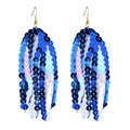 Macro shot of long tassel earrings with blue to iridescent pink round sequins and gold hooks - Gradient Blue/Iridescent