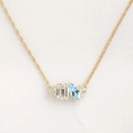 Elegant gold necklace featuring emerald-cut clear stone and marquise-cut light blue gem - Gold - March