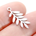 Small silver leaf pendant in stainless steel shown on fingertip for size reference - DY747 Long Leaf / Steel