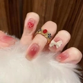 Vintage gold ring with oval red gemstone and blue accents shown on manicured hand - Glue Style (D-37)