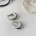 Minimalist silver-tone water drop earrings in a thick oval design on a white textured background - Silver